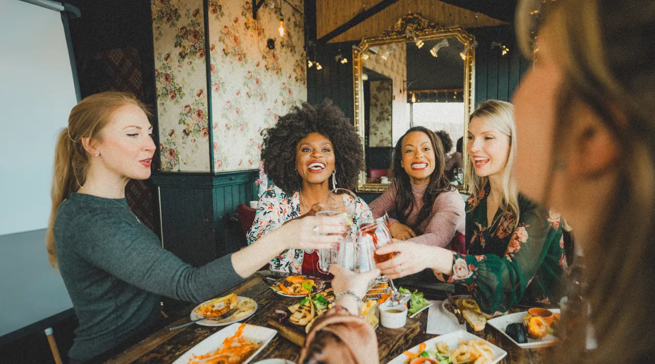 Women toasting around a dinner table